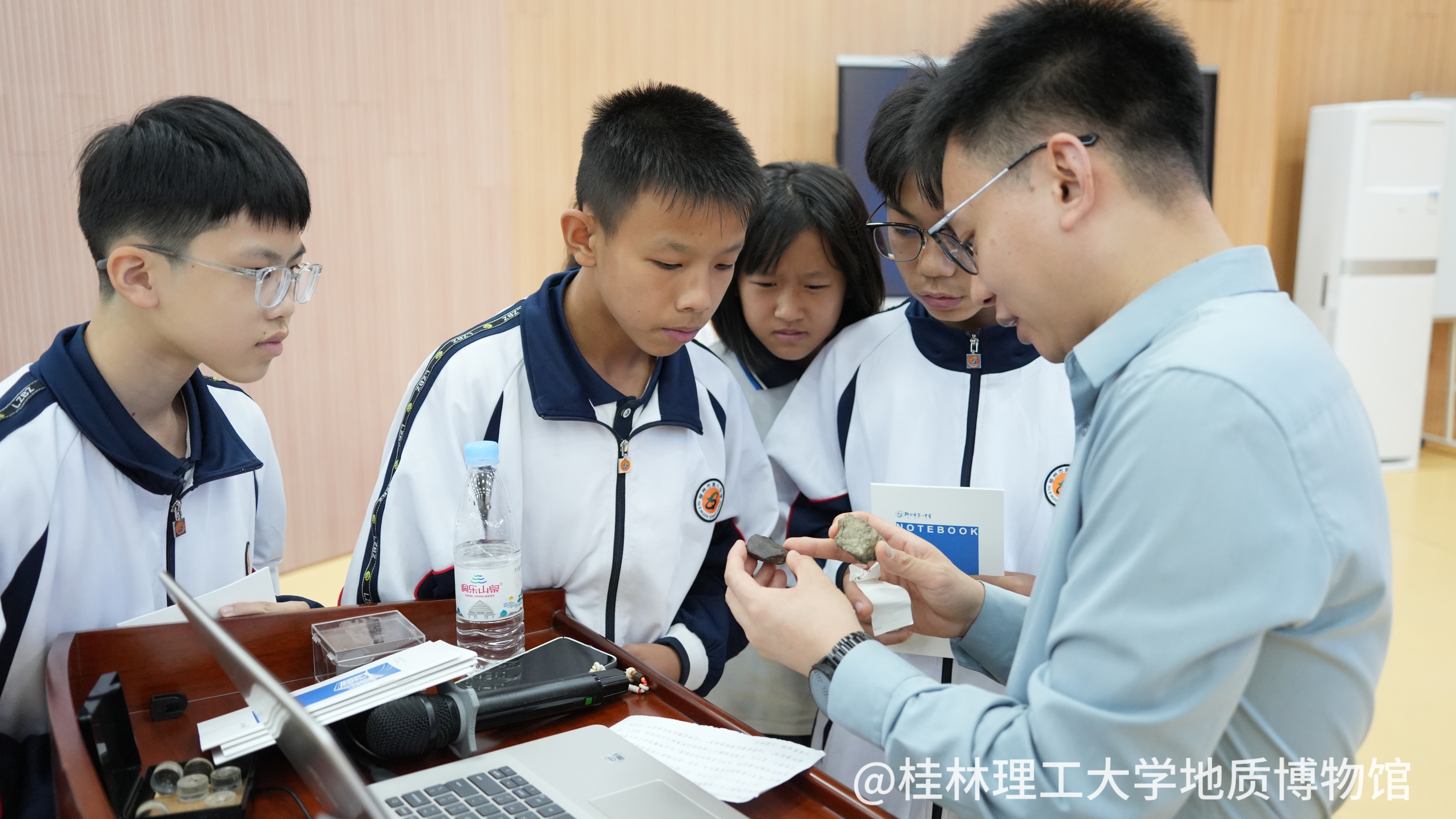 和柳州市第八中学的同学们一起观察陨石样品并讲解有关知识